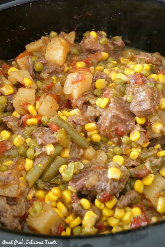 Slow Cooker Beef Stew is packed full of vegetables and beef then slow cooked until tender. Slow Cooker Beef Stew shows a picture of the meat and vegetables in the slow cooker.