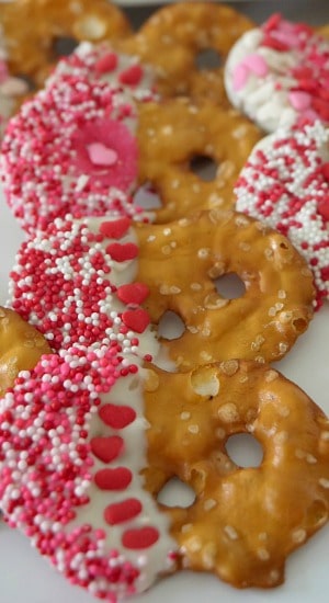 Valentine Pretzels are easy to make with only two ingredients plus sprinkles. Delicious, these are a perfect Valentine's Day recipe. Valentine Pretzels