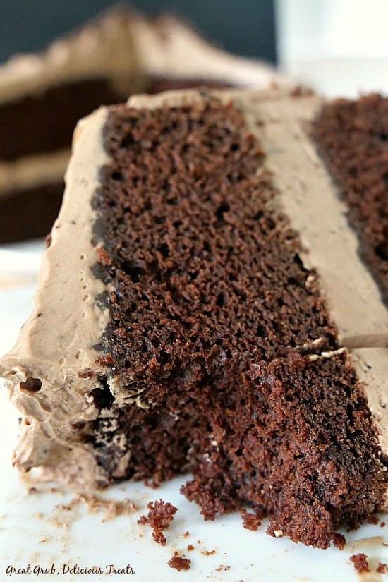 Chocolate Cake with Mocha Mascarpone Frosting is a two layer chocolate espresso cake with the best homemade mascarpone frosting. A piece of cake on a white plate with a bite taken out.