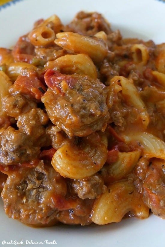 Cheesy Italian Sausage Pasta is an easy one pot pasta recipe that is cheesy and full of Italian sausage and pasta. Cheesy Italian Sausage Pasta is a picture of a bowl full of pasta with noodles and sausage.