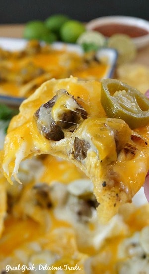 Rib Eye Nachos are a simple appetizer recipe using leftover rib eye steak and uses two types of cheese and topped with jalapenos.