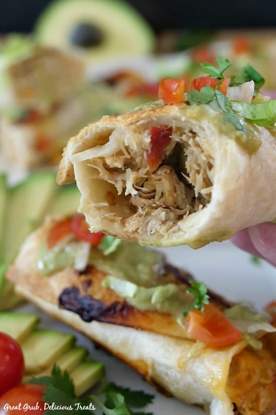 Spicy Chicken Flautas are deliciously seasoned shredded chicken breasts stuffed inside flour tortillas and then baked. Spicy Chicken Flautas - a picture of a chicken flauta that shows the inside chicken mixture.