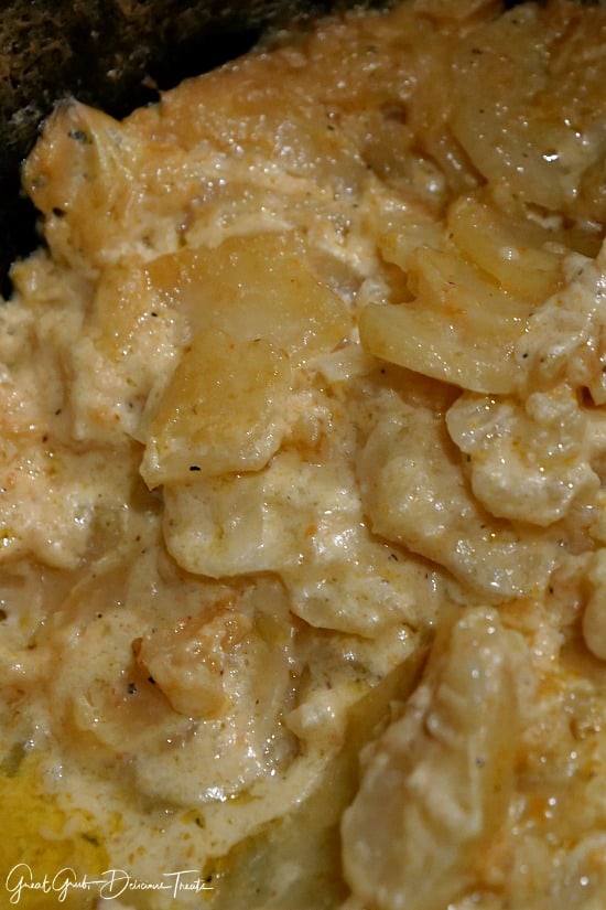 Crock Pot Cheesy Scalloped Potatoes are tender potatoes cooked in a delicious cheese sauce. #crockpotrecipeideas #yum #delish #sidedishrecipes #greatgrbudelicioustreats Crock Pot Cheesy Scalloped Potatoes