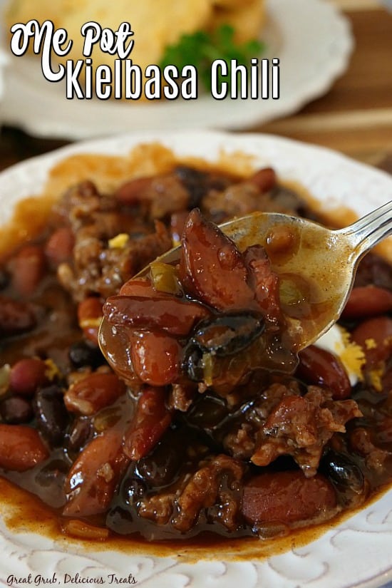 One Pot Kielbasa Chili is an easy one pot chili recipe, loaded with kielbasa sausage and perfect for a weeknight dinner. One Pot Kielbasa Chili - A close up picture of a spoonful of chili in a white bowl.