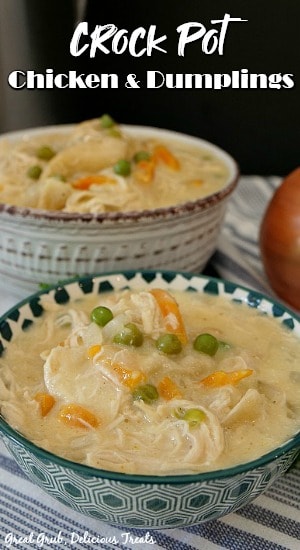 Crock Pot Chicken and Dumplings is an easy comfort food recipe that is loaded with perfectly seasoned chicken, hearty vegetables, and deliciously fluffy dumplings. Teal and white spotted bowl filled with chicken and dumplings with another white and burgundy bowl in the background full of chicken and dumplings.