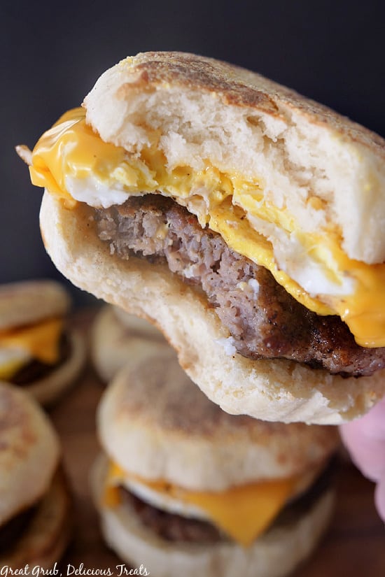 Breakfast Sandwiches are a super easy recipe to assemble and make an amazing meal for weekday mornings or large gatherings. A close up photo of a breakfast sandwich with a bite taken out of it.