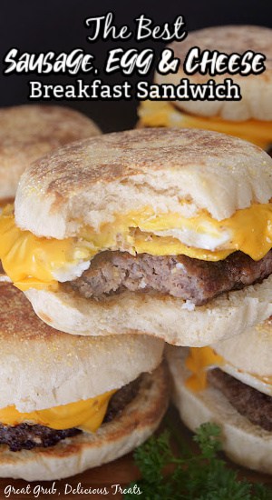 Homemade Breakfast Sandwiches are homemade breakfast sandwiches that are made with a homemade English muffin, hand pressed sausage patties, a fried egg, and topped with a slice of gooey cheese. Breakfast sandwiches stacked up on each other with a bite taken out of one.