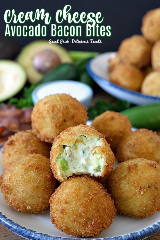Cream Cheese Avocado Bacon Bites on a white plate with blue trim with a bite taken out of the one in front.