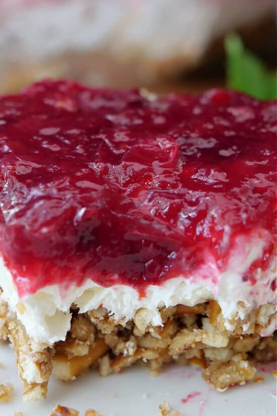 A close up of a serving of cranberry pretzel salad.