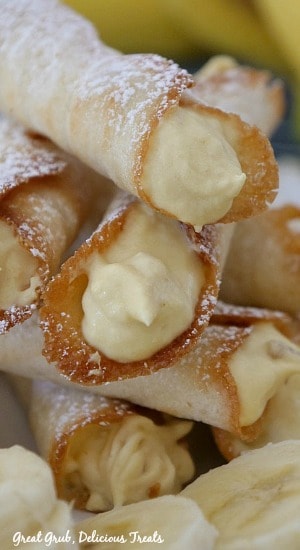 Banana Mousse Cookies are crispy, thin cookies rolled into a cannoli and then filled with banana mousse. #bananarecipe #cannolisrecipe #desserttable #bananamousse #greatgrubdelicioustreats