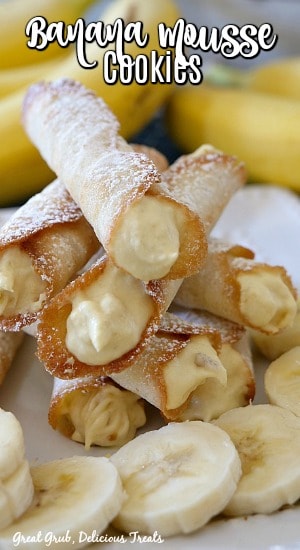 Banana Mousse Cookies are thin and crispy cookies rolled up and stuffed with a homemade banana mousse filling. #bananacookierecipe #bananacannoli #homemadecookierecipe #easyrecipe #greatgrubdelicioustreats