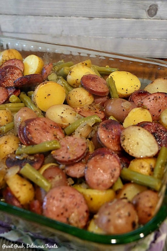Sausage Green Bean Potato Casserole has delicious flavor, loaded with sliced kielbasa, green beans and potatoes. A glass baking dish filled with sausage green beans and potatoes.