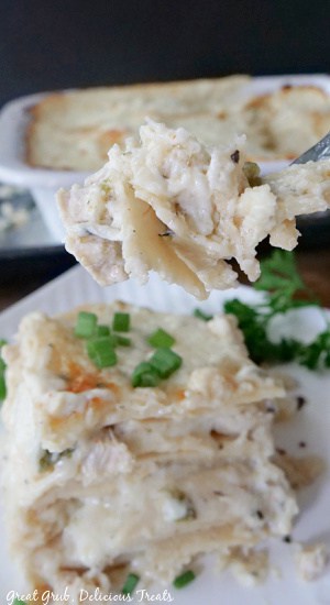 A bite of chicken enchilada on a fork.