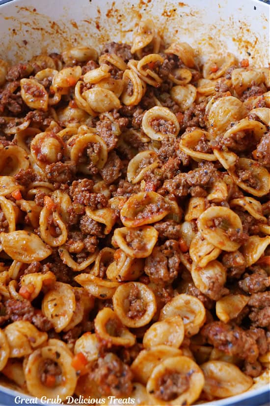 A pot filled with pasta bolognese.