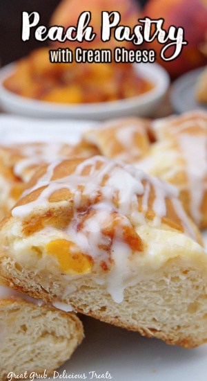 A few pieces of peach pastry on a white plate with a small white bowl filled with cubed peaches in the background.