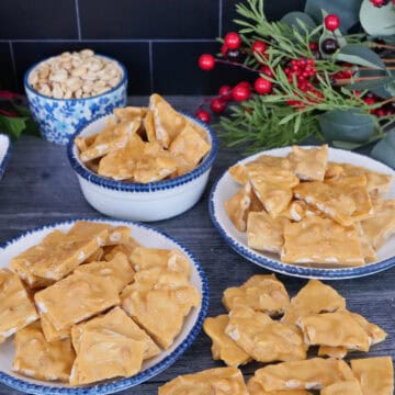 A grey surface with three different plates with homemade peanut brittle on them, and the title overlay at the top.