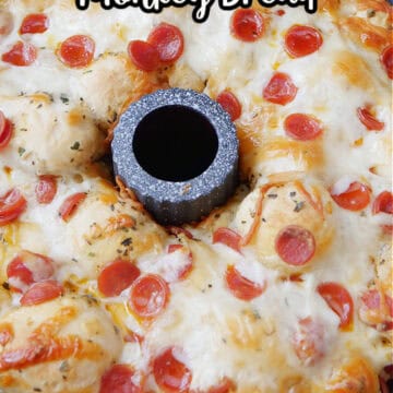 Pepperoni pizza pull apart bread in a bundt pan after being removed from the oven with the title of the recipe at the top in text.