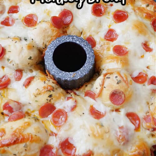 Pepperoni pizza pull apart bread in a bundt pan after being removed from the oven with the title of the recipe at the top in text.