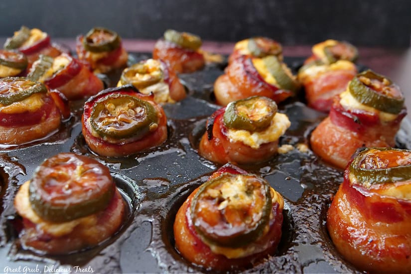 A mini muffin pan with pig shot appetizers that were just pulled from the oven.