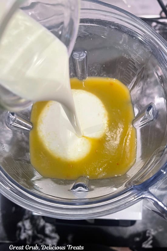 Heavy cream is added to the blender.