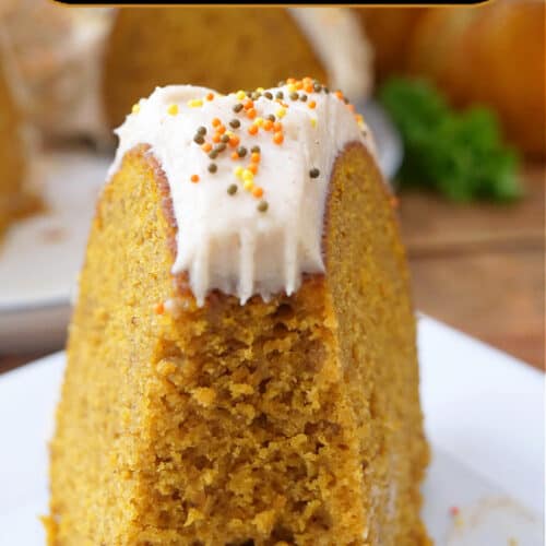 A white plate with a slice of pumpkin bundt cake on it.