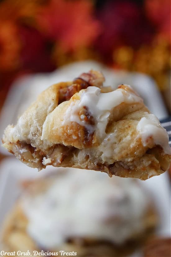 A bite of cinnamon roll on a fork.