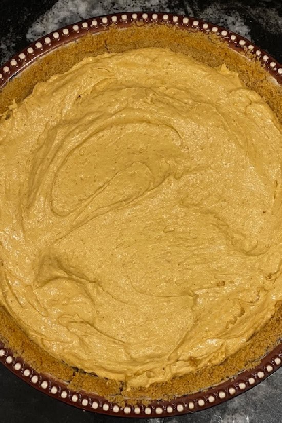 A pie dish with the pumpkin spice mixture put into a graham cracker crust.