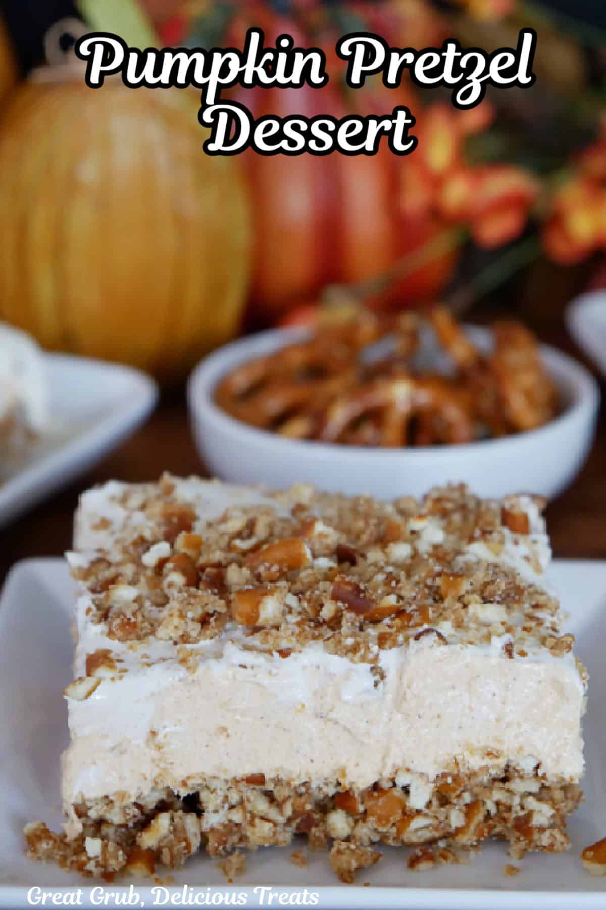 A white plate with a slice of pumpkin pretzel dessert on it.