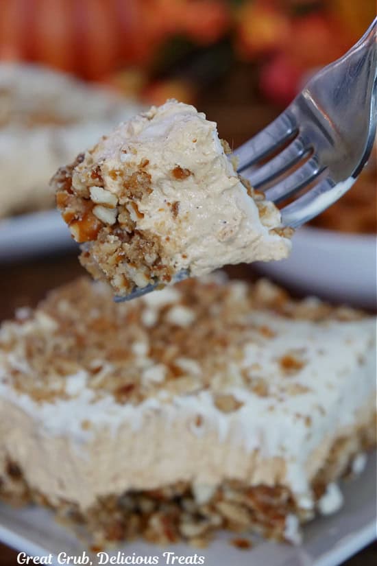 A bite of pumpkin pretzel dessert on a fork.