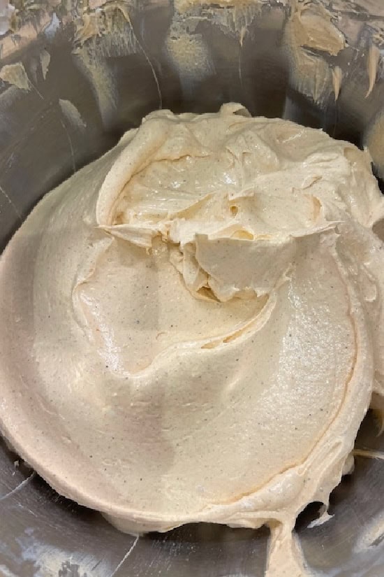 A mixing bowl with the pumpkin cream cheese mixture all mixed together.