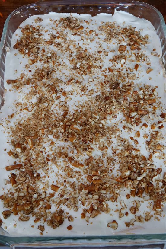 A baking dish with the pumpkin pretzel dessert in it before being sliced.