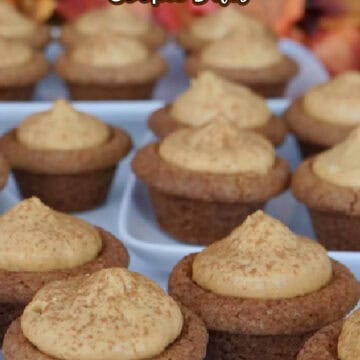 A white surface with over a dozen mini pumpkin spice cookie bites on it.