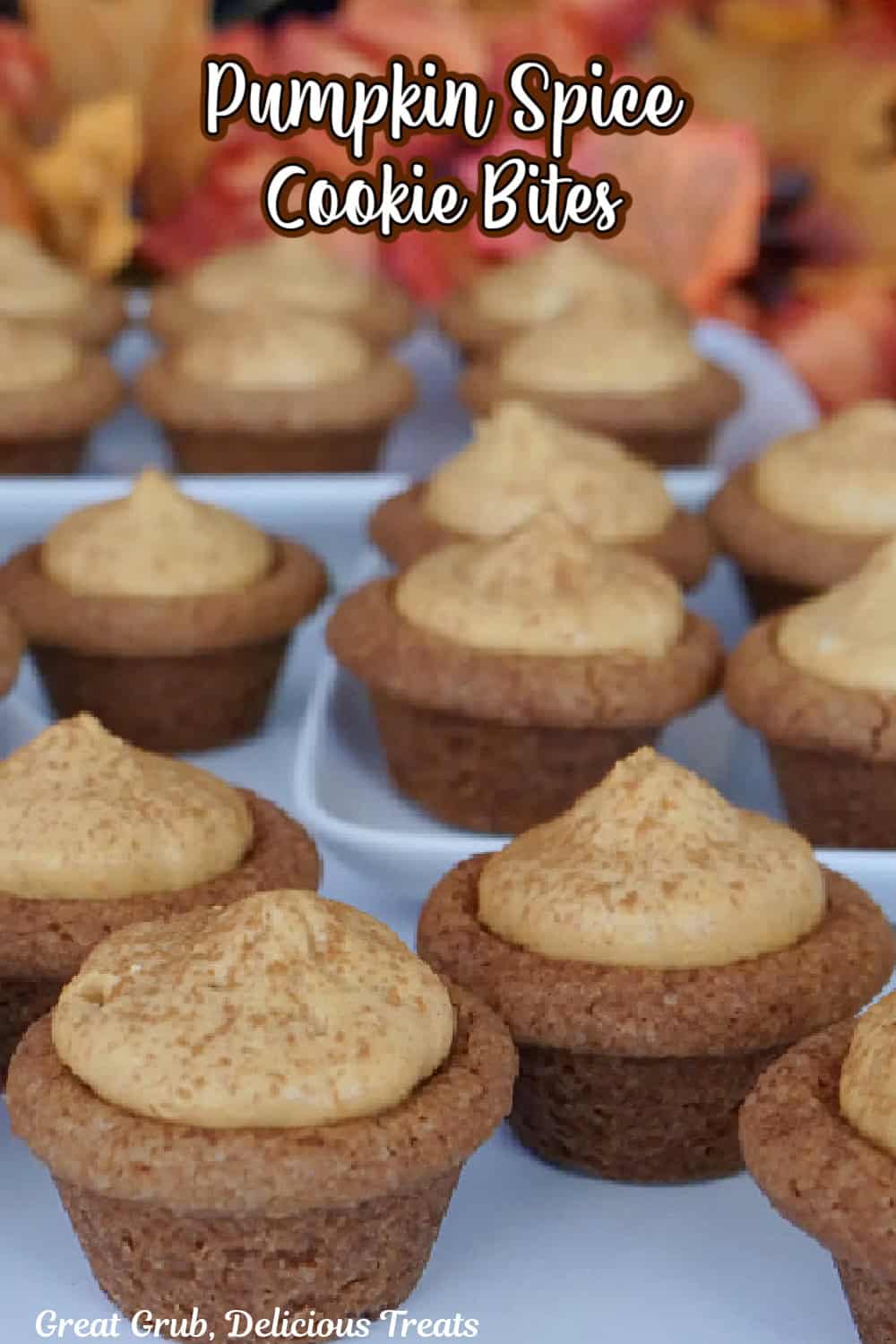 A white surface with more than a dozen mini pumpkin spice cookie bites on it.