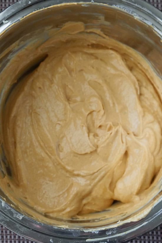 A mixing bowl with the cream cheese mixture and the pumpkin spice pudding mixture mixed together.