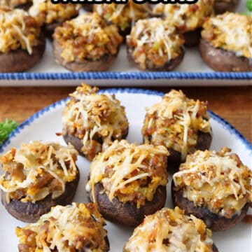 Two white plates with blue trim filled with sausage stuffed mushrooms.