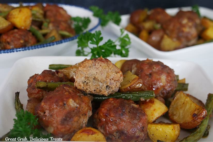 Three white plates with a serving of meatballs, potatoes, and green beans.