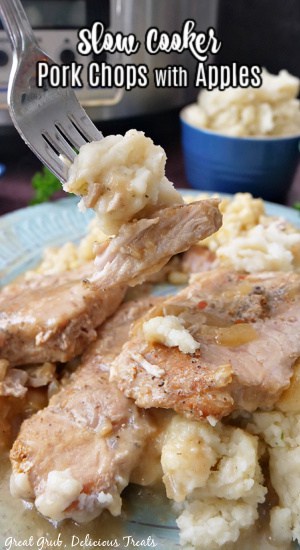 Slow Cooker Pork Chops with Apples is an easy, leave it and forget it, crock pot recipe that makes the best pork chops. A bite of pork chops and potatoes on a fork.
