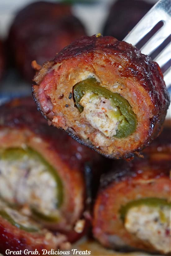 A bite of bacon wrapped armadillo egg on a fork.