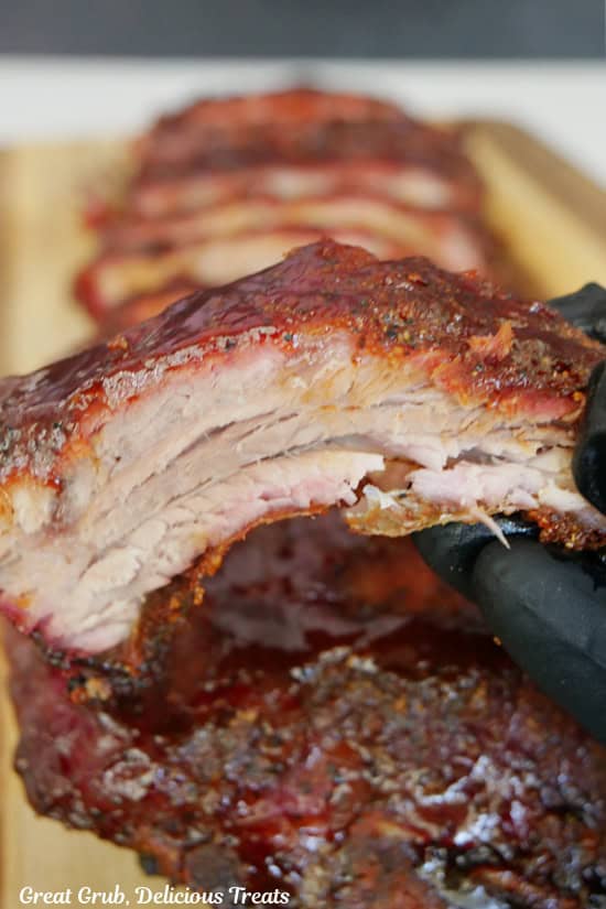 A meaty pork rib with BBQ sauce on top.