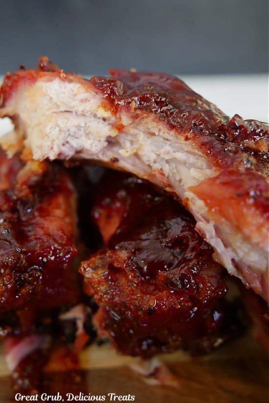 A smoked BBQ pork rib with a bite taken out of it.