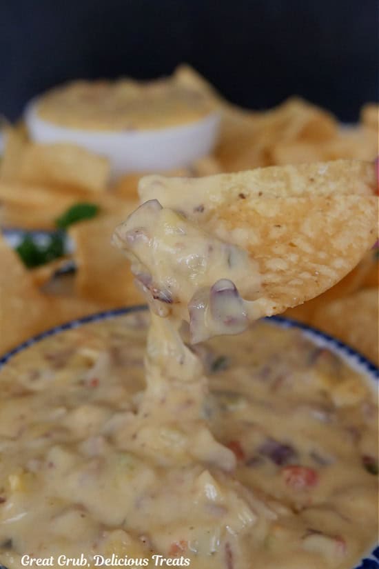 A tortilla chip dipped in smoked brisket queso.
