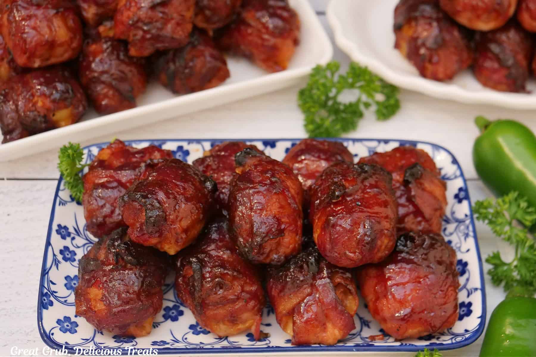A white surface with three plates filled with stacks of smoked shotgun shell bites.