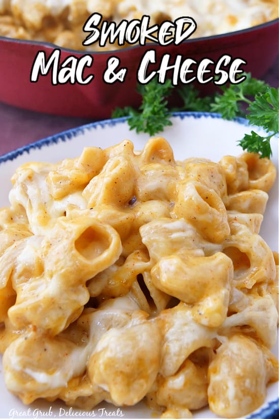 A white bowl with blue trim loaded with mac and cheese.