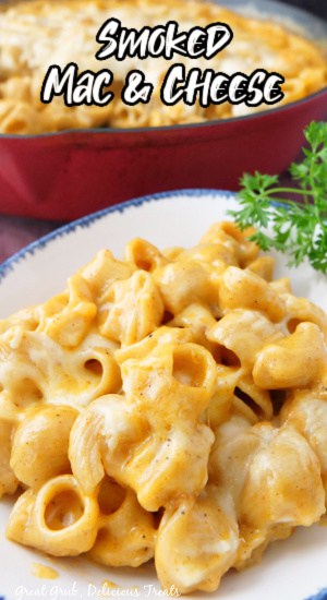 Smoked Mac and Cheese is an easy way to make smokey tasting mac and cheese right in the oven. A title pic with a bowl of mac and cheese with a cast iron in the background.