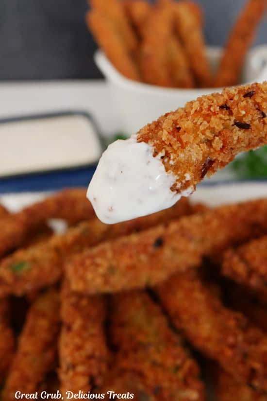 A spicy green bean that is dipped in ranch dressing.