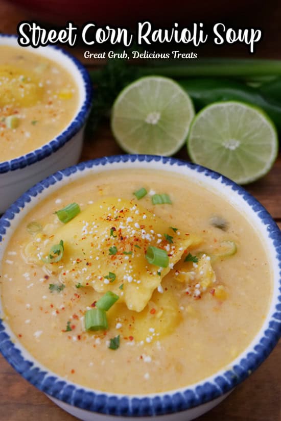 Two white soup bowls with blue trim filled with a serving of street corn ravioli soup.