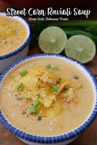 A white bowl with blue trim filled with street corn ravioli soup.