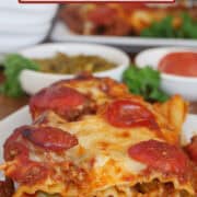 A white plate with a serving of supreme pizza stuffed manicotti on it with the title overlay at the top.