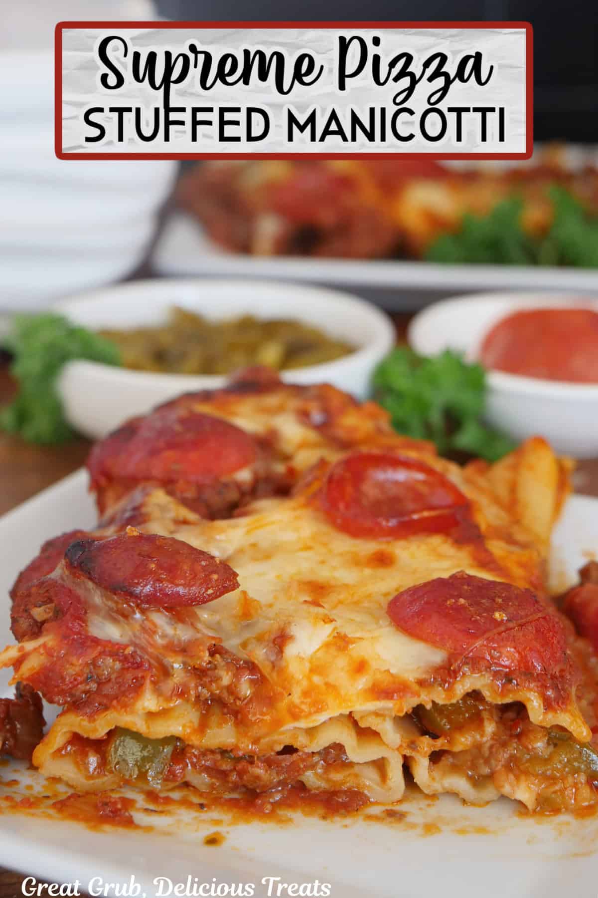 A white plate with a serving of supreme pizza stuffed manicotti on it with the title overlay at the top.