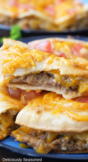 A close up photo of a few slices of a copycat Taco Bell Mexican Pizza recipe with one piece of top of another.